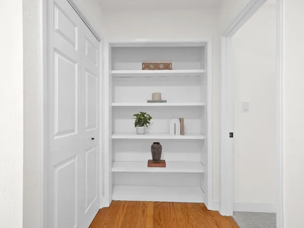 a spacious bedroom with a large bed and a large window