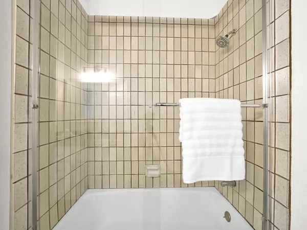 a bathroom with a glass shower door