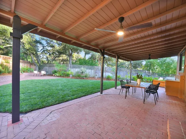 a view of a house with a backyard and porch