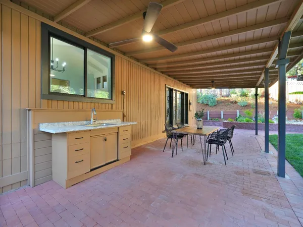 a table and chairs with the view of garden