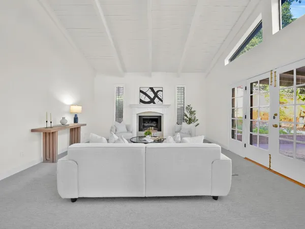 a living room with furniture and a chandelier