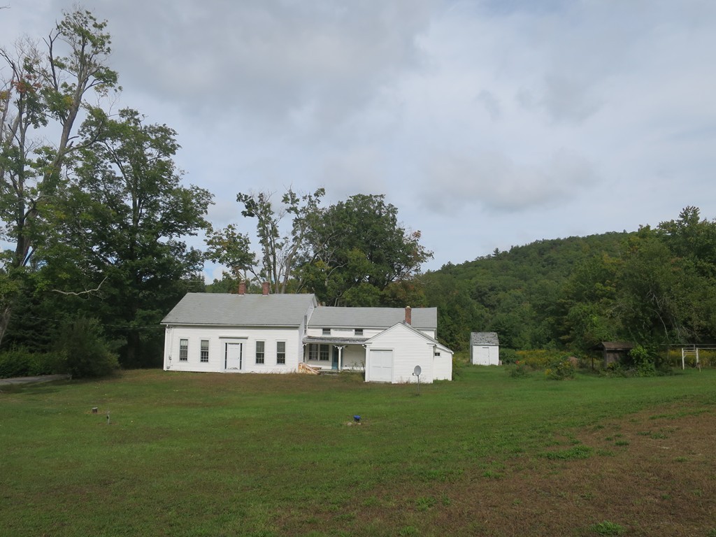 66 Butler Road Monson, MA 01057 - Photo 4 of 11 a view of a big house with a big yard and large trees