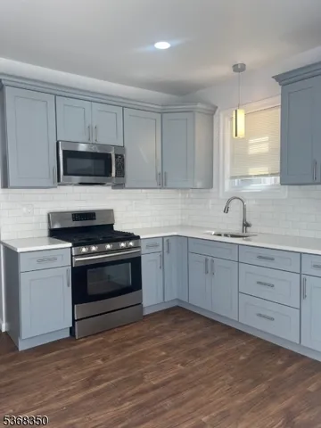 a kitchen with granite countertop cabinets and steel stainless steel appliances