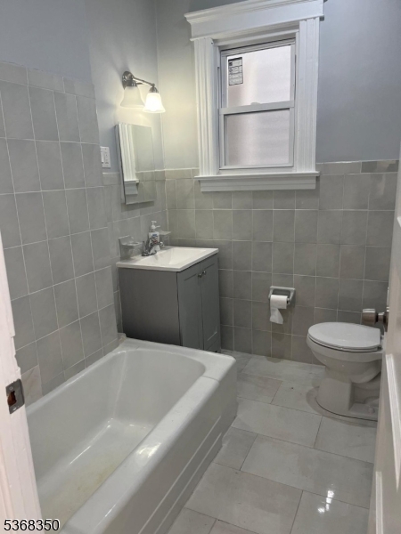 414 21st Avenue Paterson, NJ 07513 - Photo 5 of 9 a bathroom with a bathtub and window