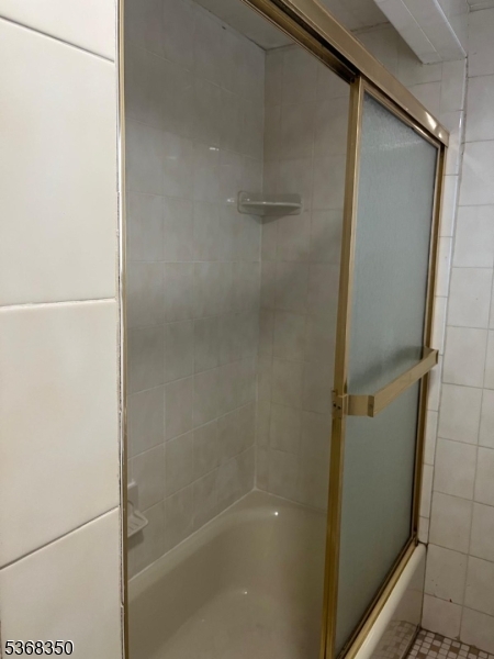 414 21st Avenue Paterson, NJ 07513 - Photo 9 of 9 a bathroom with a glass shower door