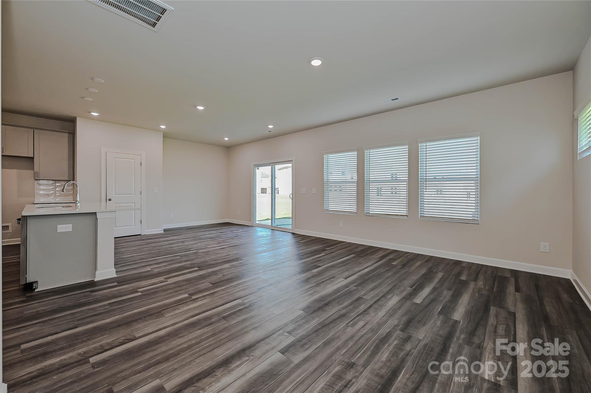 1500 31st Street Northeast Conover, NC 28613 - Photo 2 of 12 an empty room with wooden floor and windows