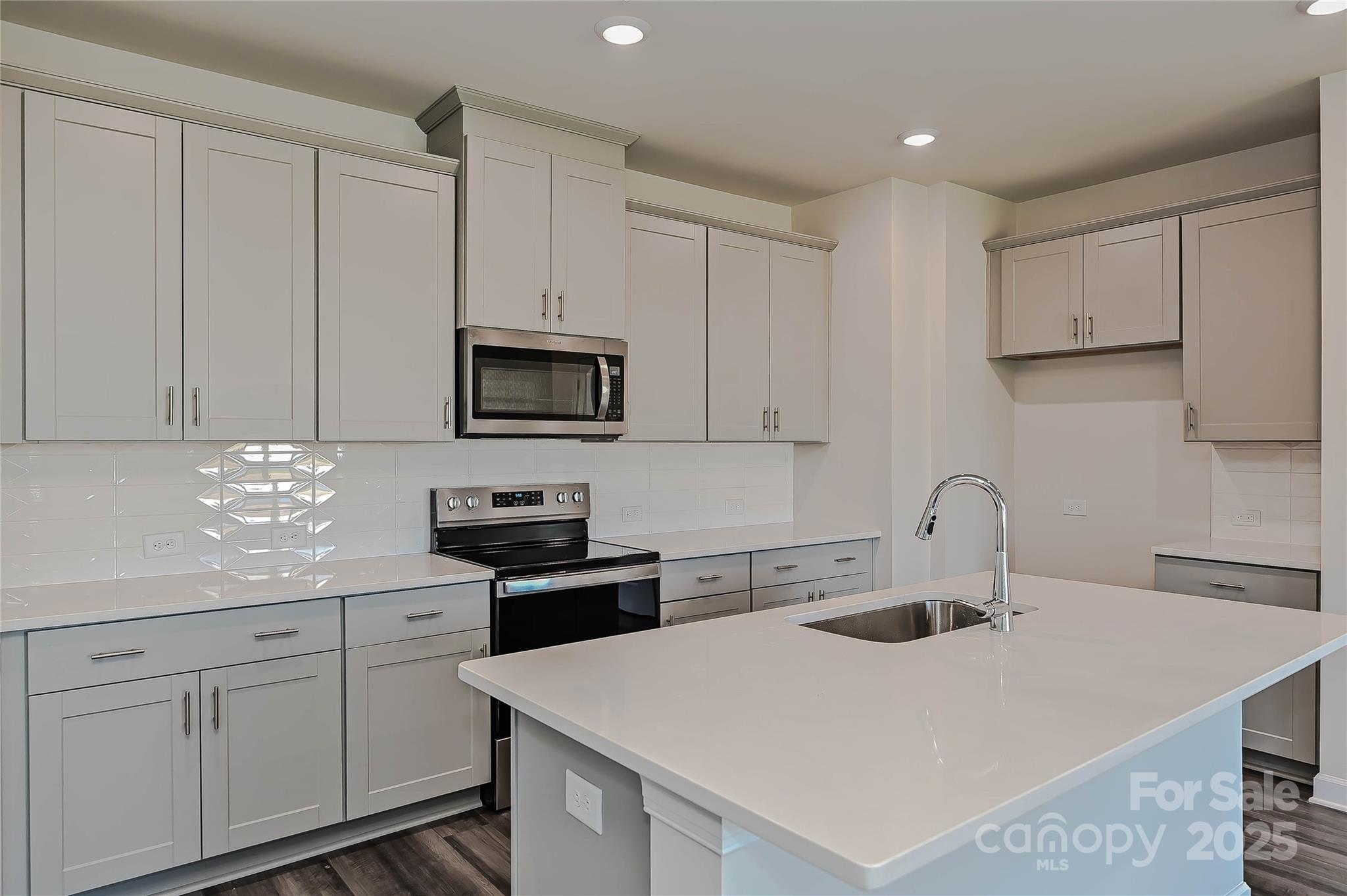 1500 31st Street Northeast Conover, NC 28613 - Photo 3 of 12 a kitchen with white cabinets a sink and appliances