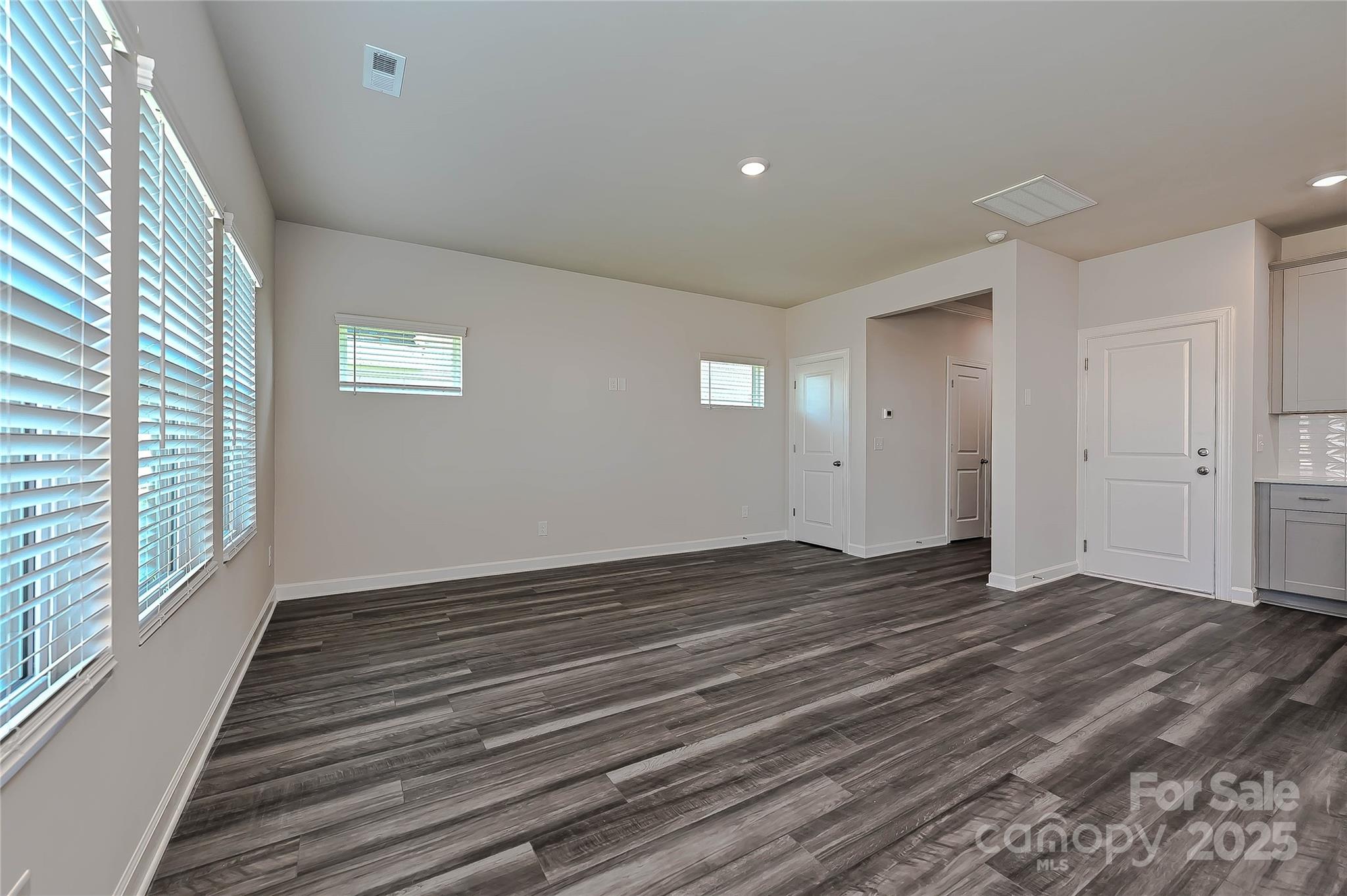1500 31st Street Northeast Conover, NC 28613 - Photo 5 of 12 a view of an empty room with wooden floor and a window
