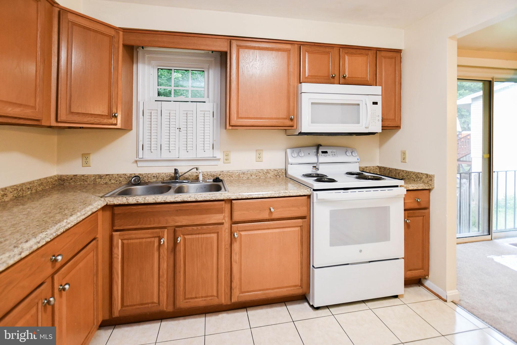 12411 Sturdee Drive Upper Marlboro, MD 20772 - Photo 12 of 39 a kitchen with stainless steel appliances granite countertop a sink stove and cabinets