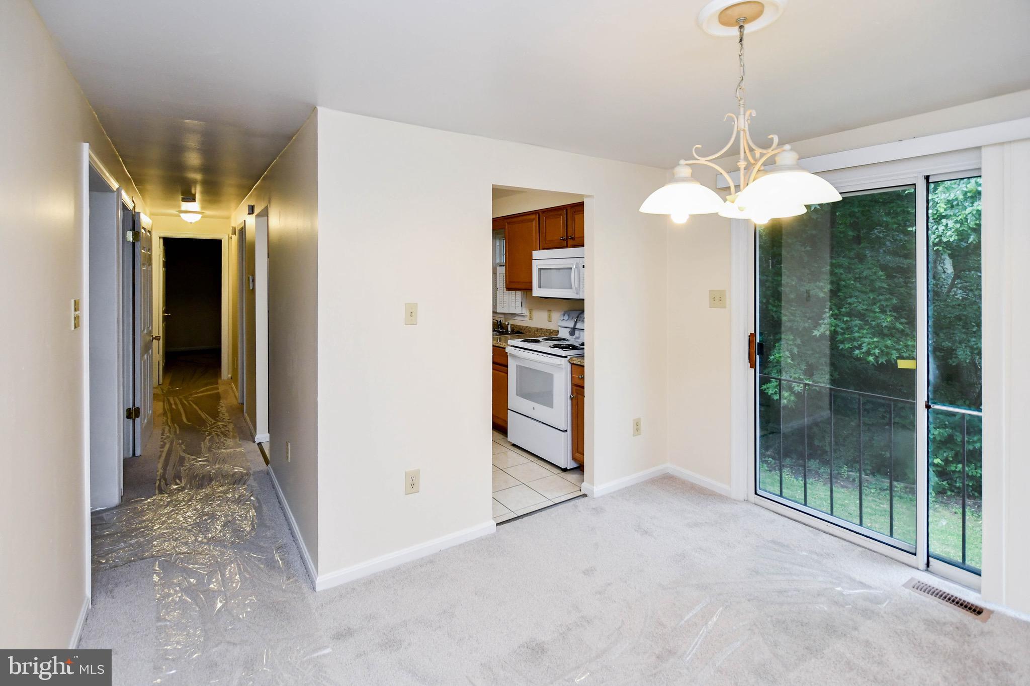 12411 Sturdee Drive Upper Marlboro, MD 20772 - Photo 14 of 39 a view of a livingroom with a chandelier & a ceiling fan