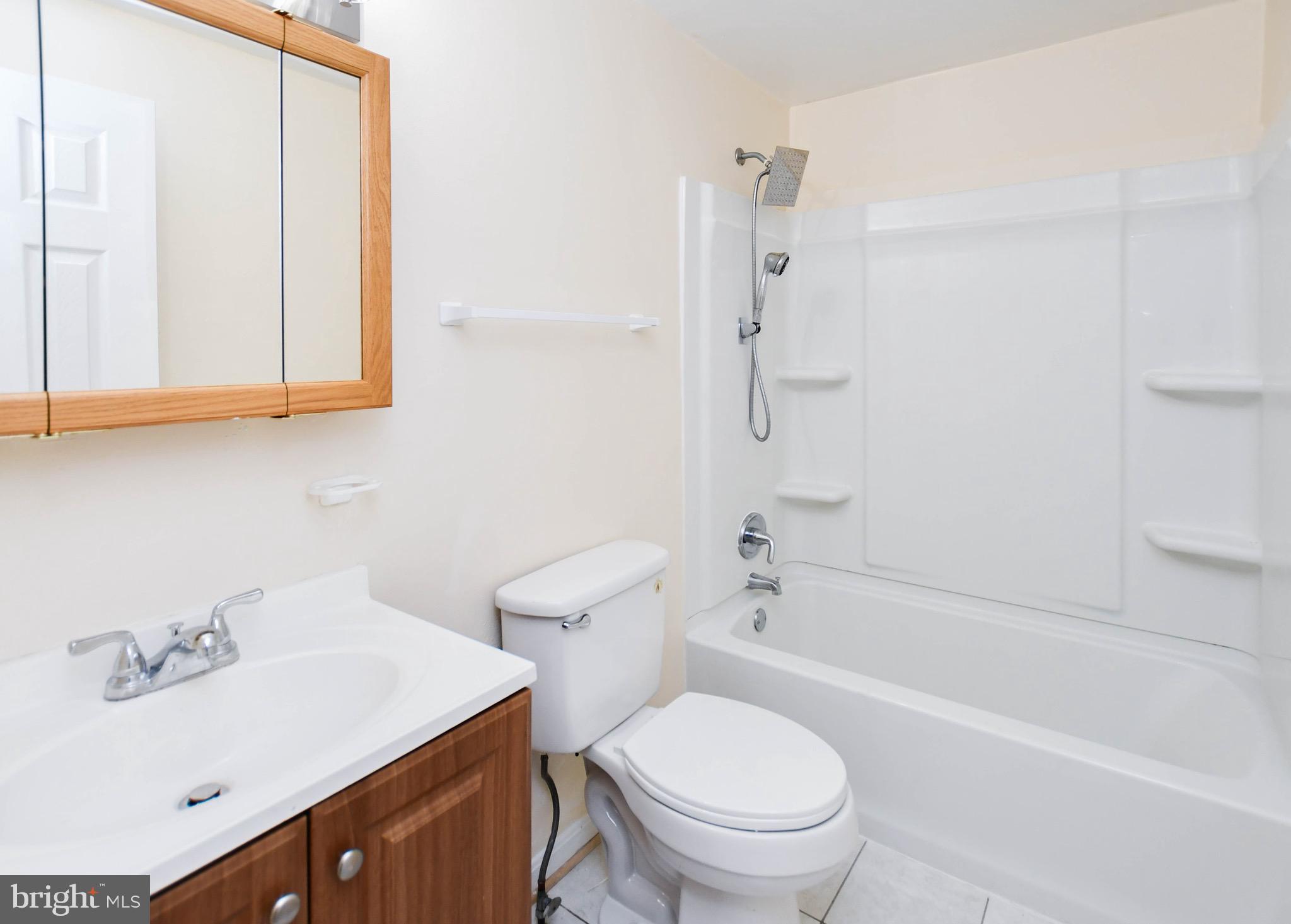 12411 Sturdee Drive Upper Marlboro, MD 20772 - Photo 16 of 39 a bathroom with a sink a toilet and shower