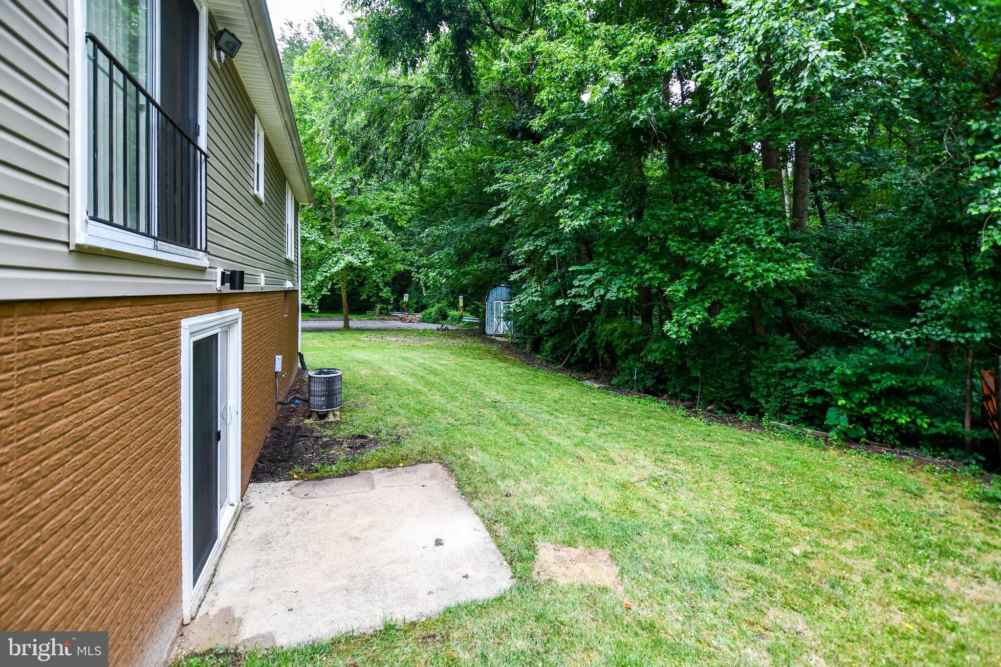 12411 Sturdee Drive Upper Marlboro, MD 20772 - Photo 37 of 39 a backyard of a house with plants and large trees