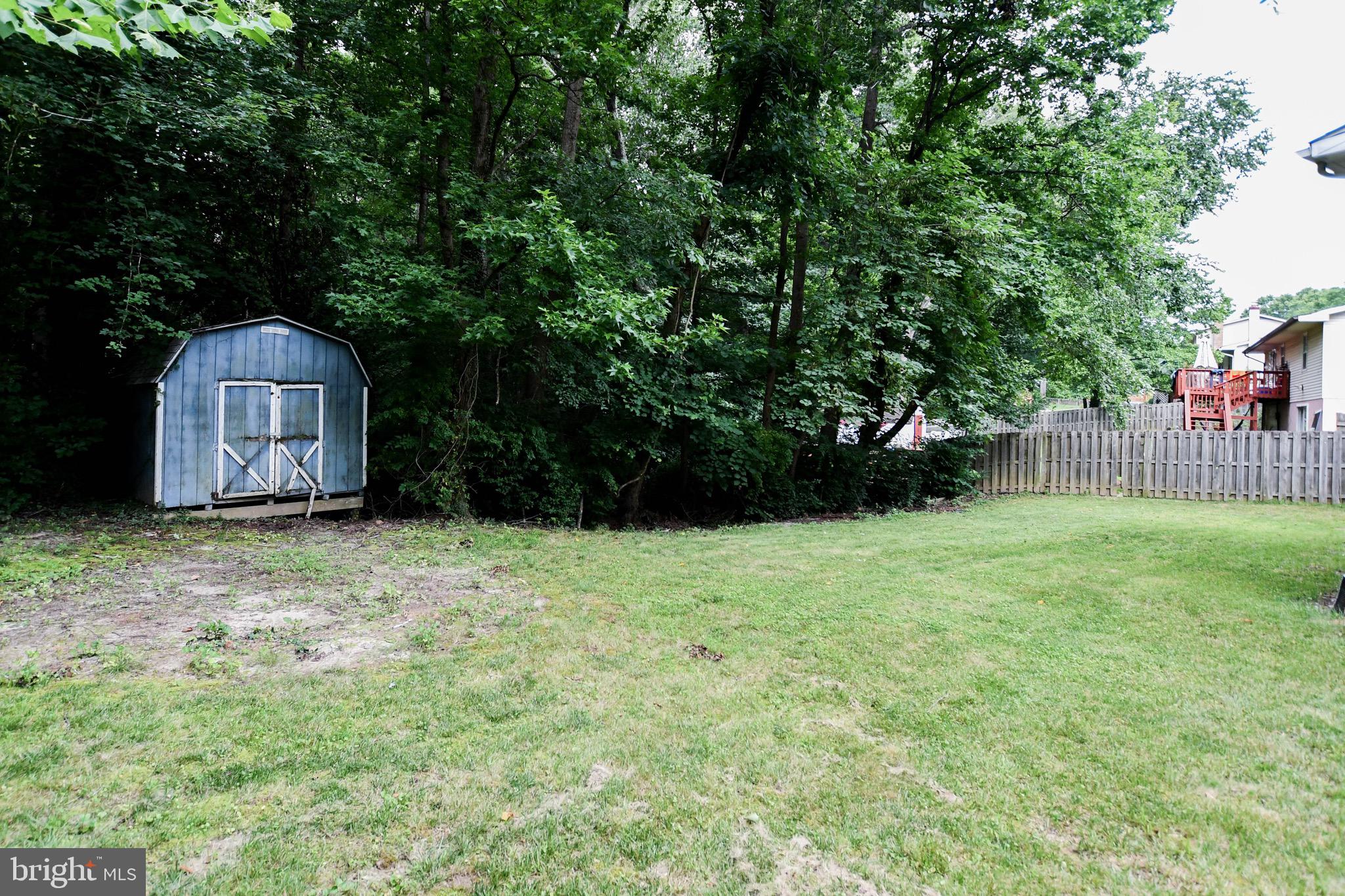 12411 Sturdee Drive Upper Marlboro, MD 20772 - Photo 39 of 39 a view of a backyard with potted plants and large tree