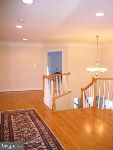 6906 Strata Street McLean, VA 22101 - Photo 29 of 30 Upper Hallway w/ Oak Flooring and Crown Mouldings