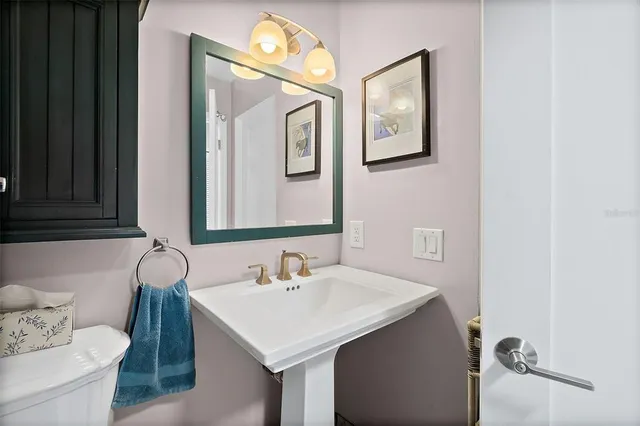 a spacious bedroom with a bed and a chandelier