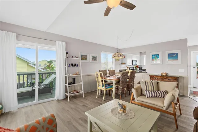 a living room with furniture a wooden floor and next to a window