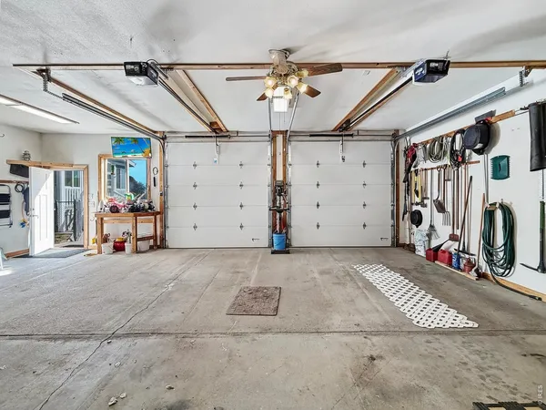 a view of a garage with wooden fence
