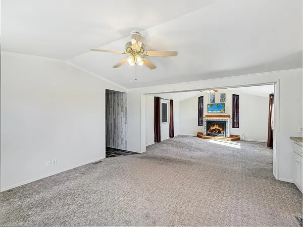 a view of an empty room with a fireplace