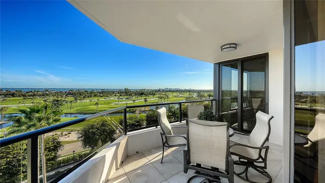 a view of a chairs and table in the balcony