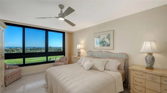 a bedroom with a large bed and a large window