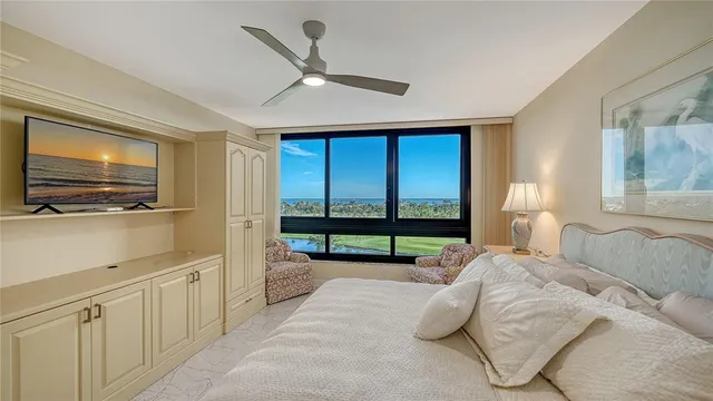 a bedroom with a bed and a flat tv screen on dresser
