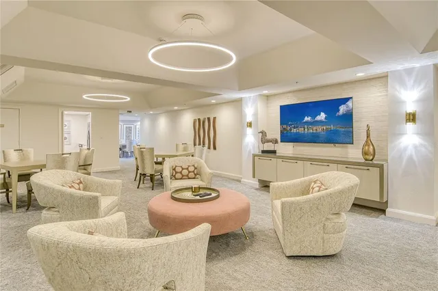 a living room with furniture and a dining table