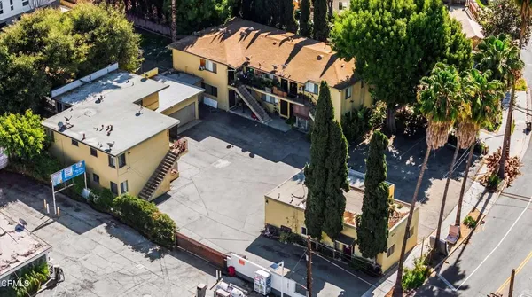 an aerial view of residential houses with outdoor space