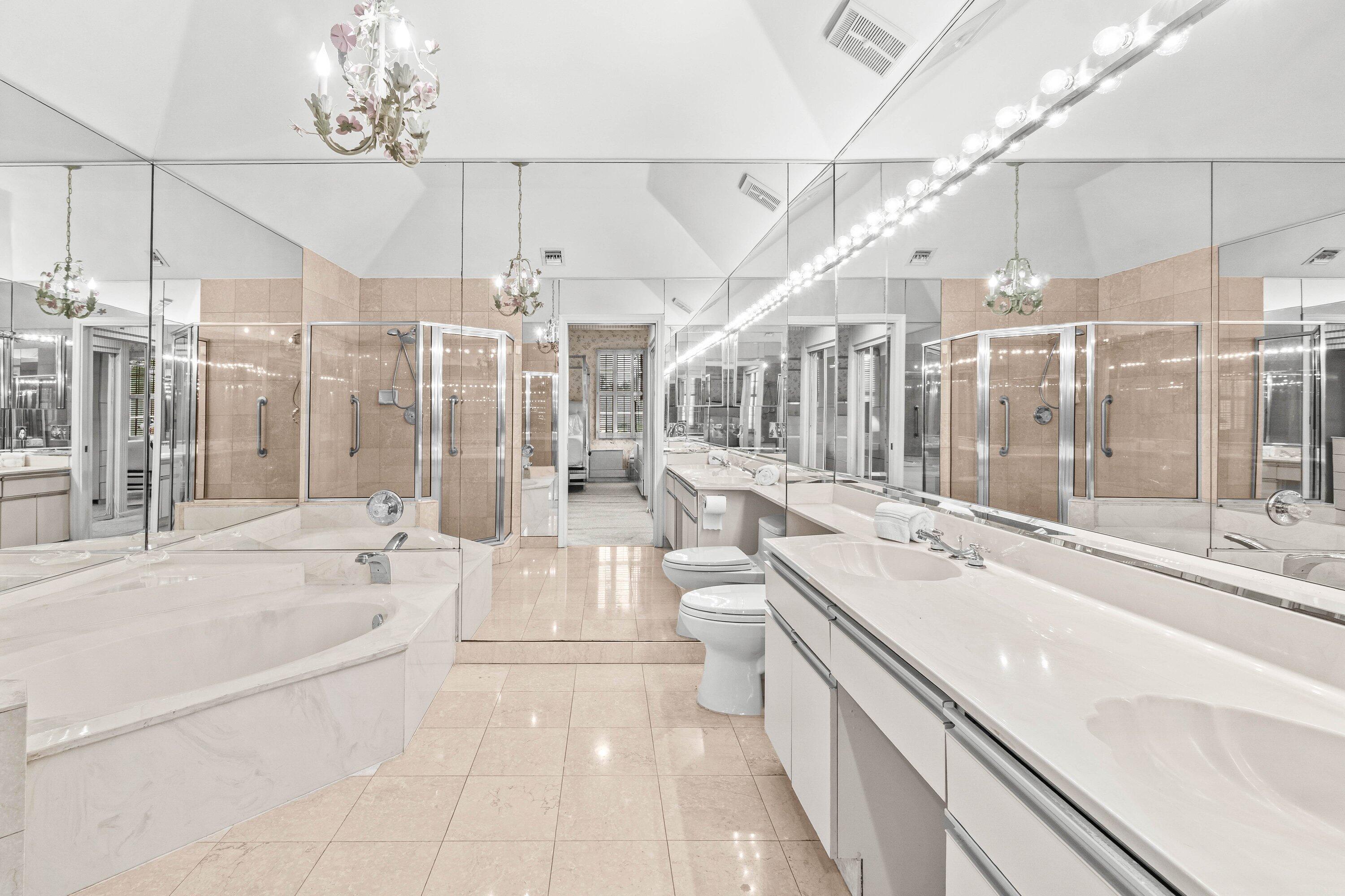 5184 Lake Catalina Drive, Unit D Boca Raton, FL 33496 - Photo 14 of 54 a large white bathroom with a large tub sink shower and view