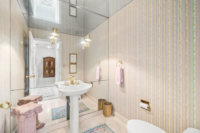 a bedroom with a bed and a chandelier fan