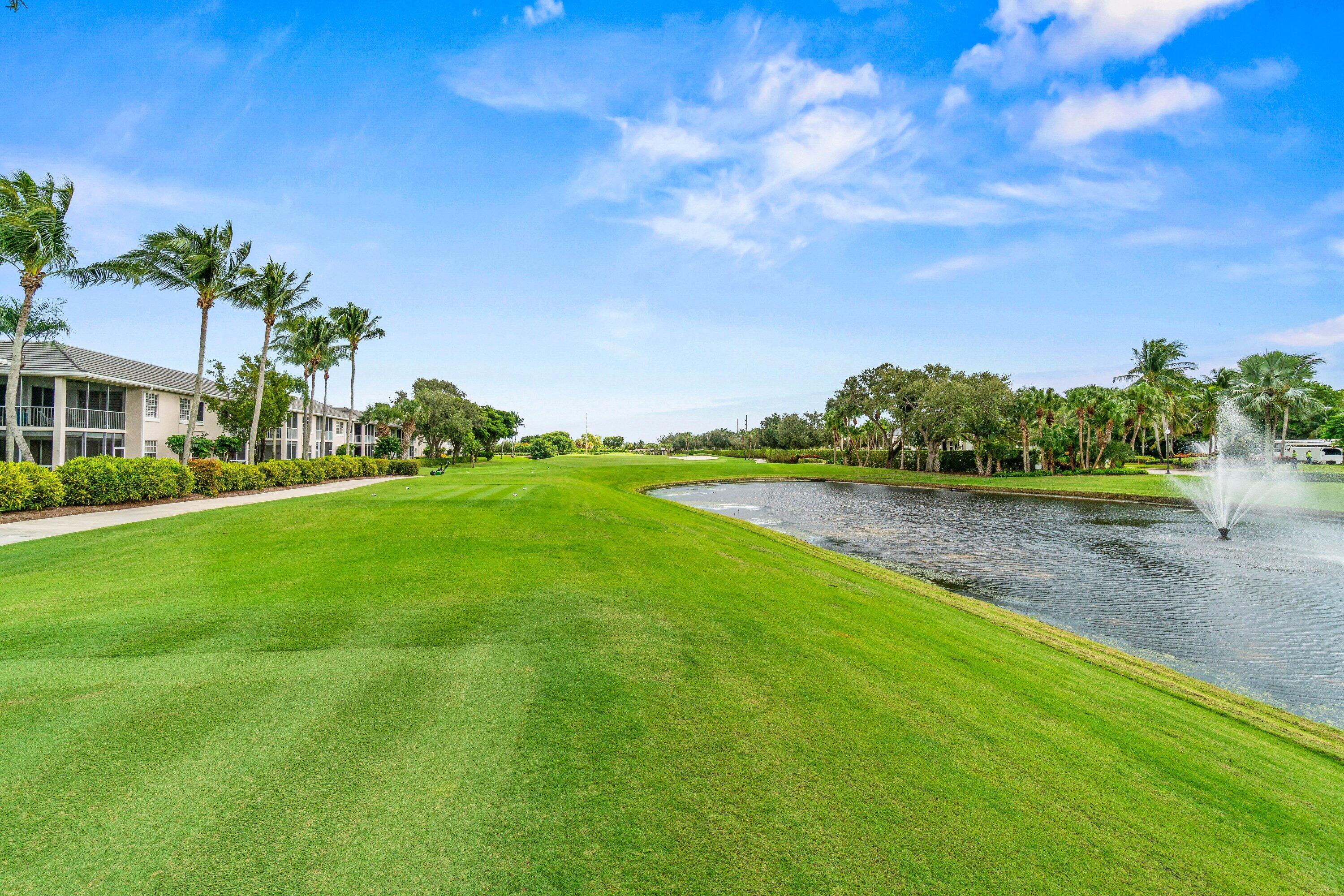 5184 Lake Catalina Drive, Unit D Boca Raton, FL 33496 - Photo 30 of 54 a front view of a house with a yard