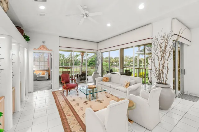 a living room with furniture and a book shelf