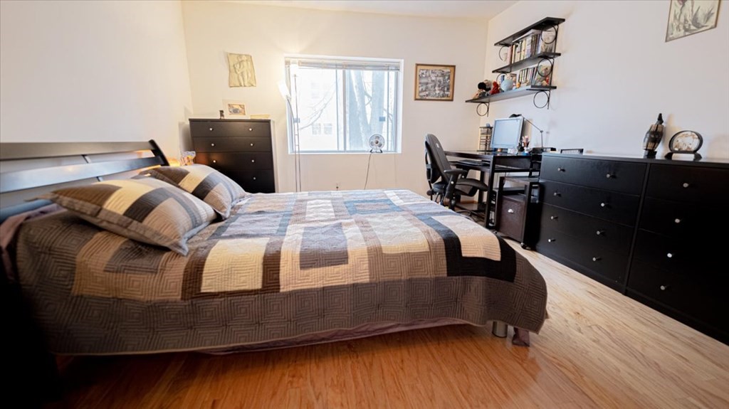 2 Larose Place, Unit 8 Boston, MA 02135 - Photo 11 of 19 a bedroom with a bed and wooden floor