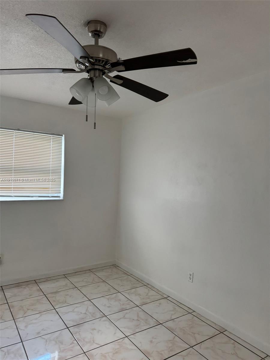 50 West 23rd Street, Unit 15 Hialeah, FL 33010 - Photo 13 of 19 a view of a room with window and a ceiling fan