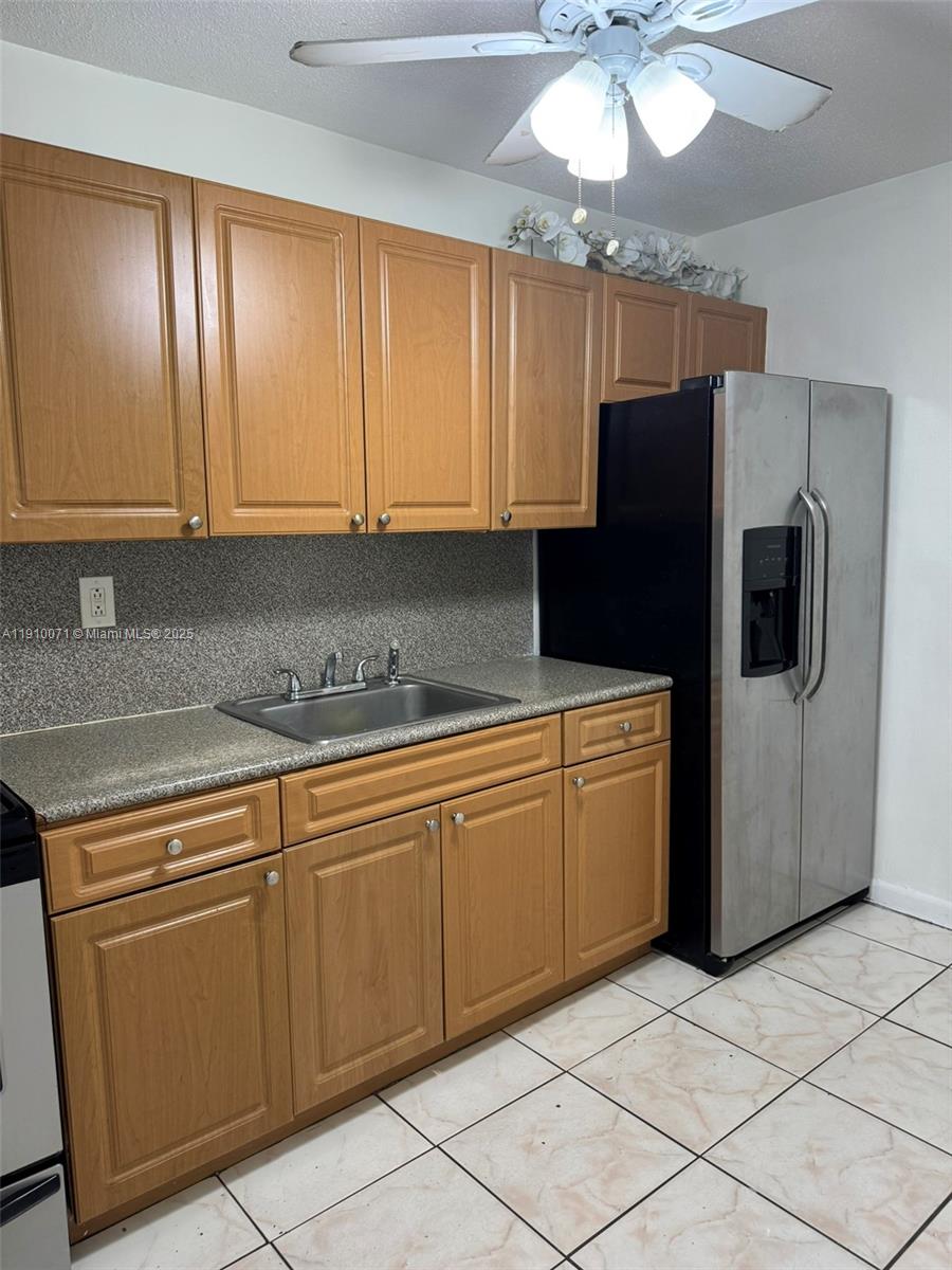 50 West 23rd Street, Unit 15 Hialeah, FL 33010 - Photo 3 of 19 a kitchen with cabinets and stainless steel appliances