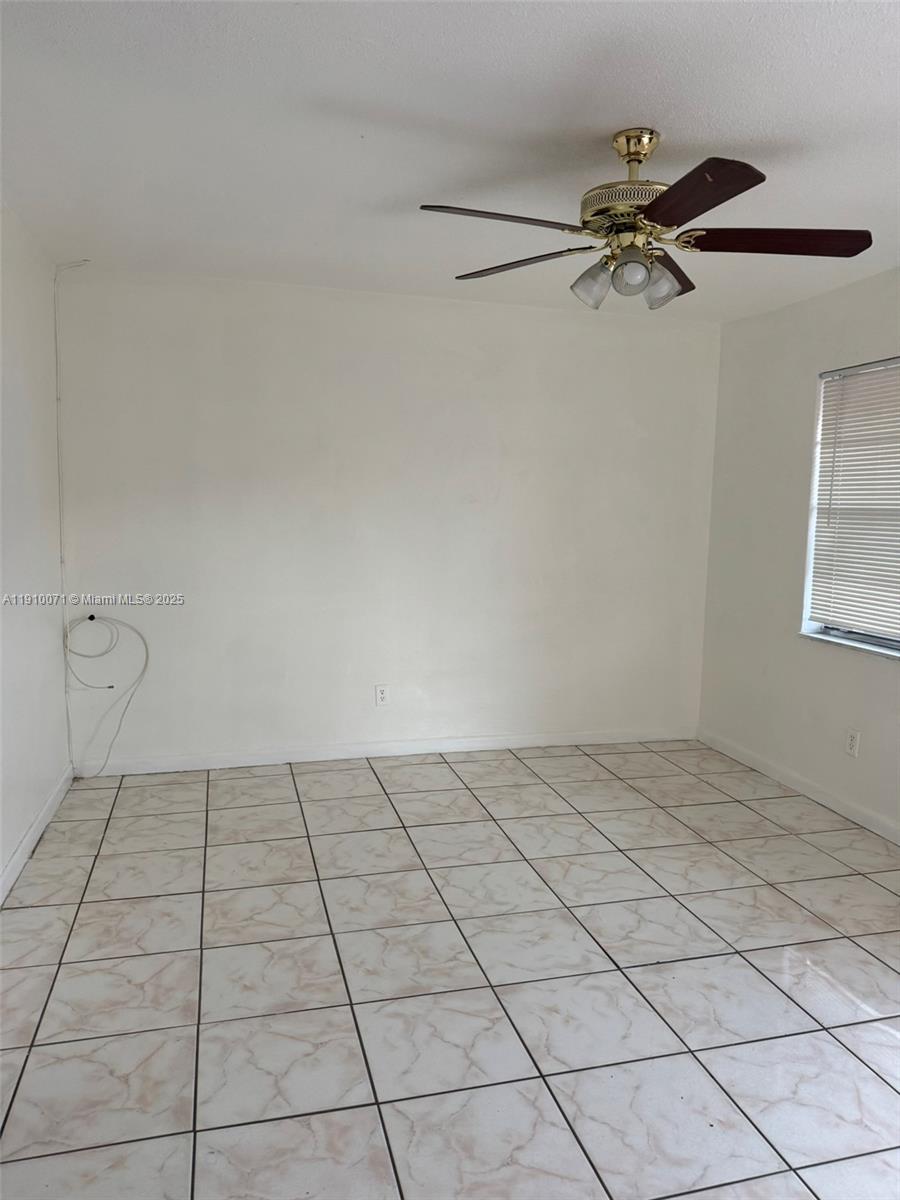 50 West 23rd Street, Unit 15 Hialeah, FL 33010 - Photo 6 of 19 a view of an empty room and a chandelier fan