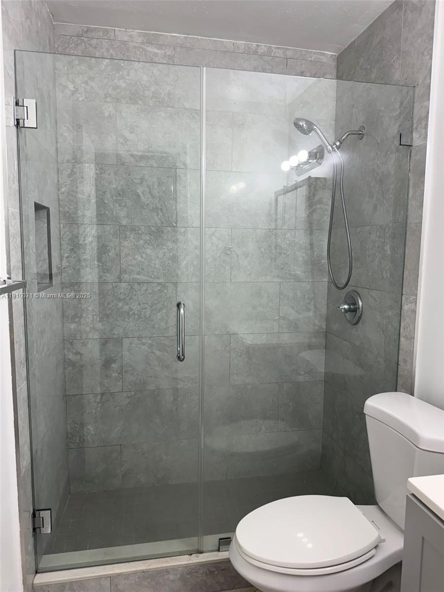 50 West 23rd Street, Unit 15 Hialeah, FL 33010 - Photo 7 of 19 a bathroom with a toilet and a shower