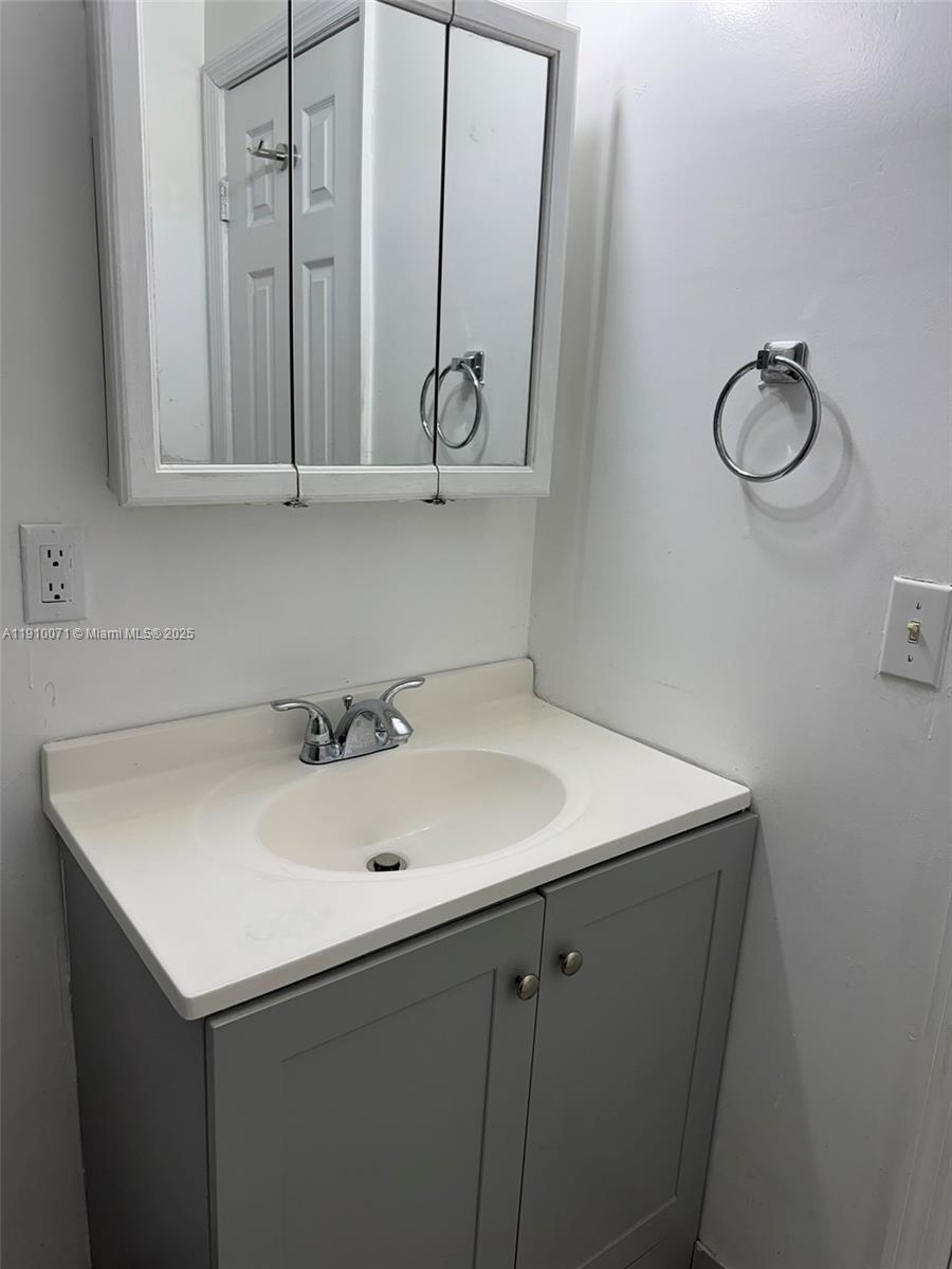 50 West 23rd Street, Unit 15 Hialeah, FL 33010 - Photo 8 of 19 a bathroom with a sink and a mirror
