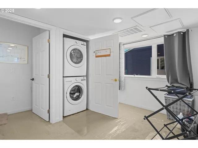 a dining hall with stainless steel appliances a dining table and chairs