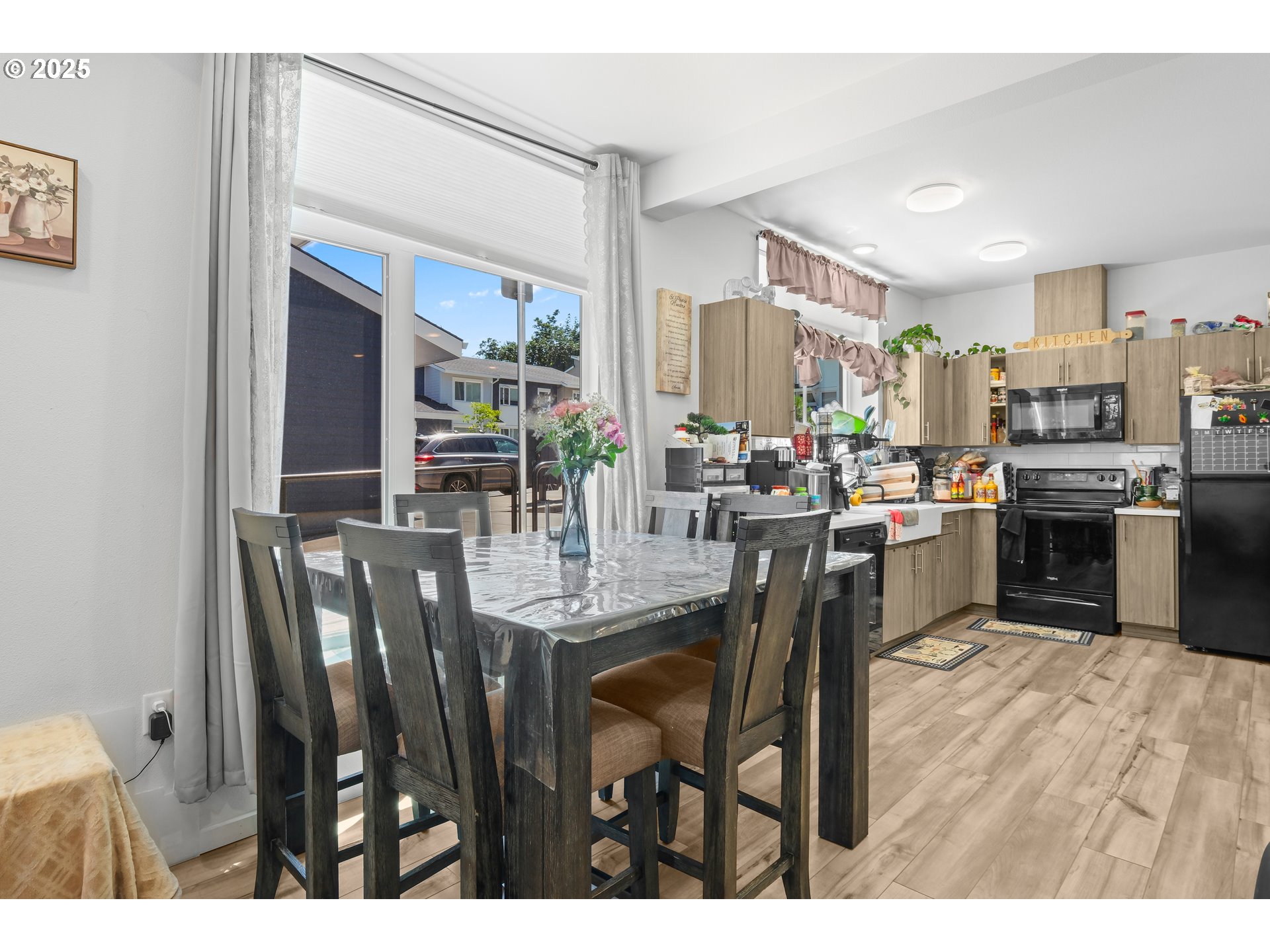 13425 Southeast Foster Road, Unit 40 Portland, OR 97236 - Photo 13 of 14 a dining hall with stainless steel appliances a dining table and chairs