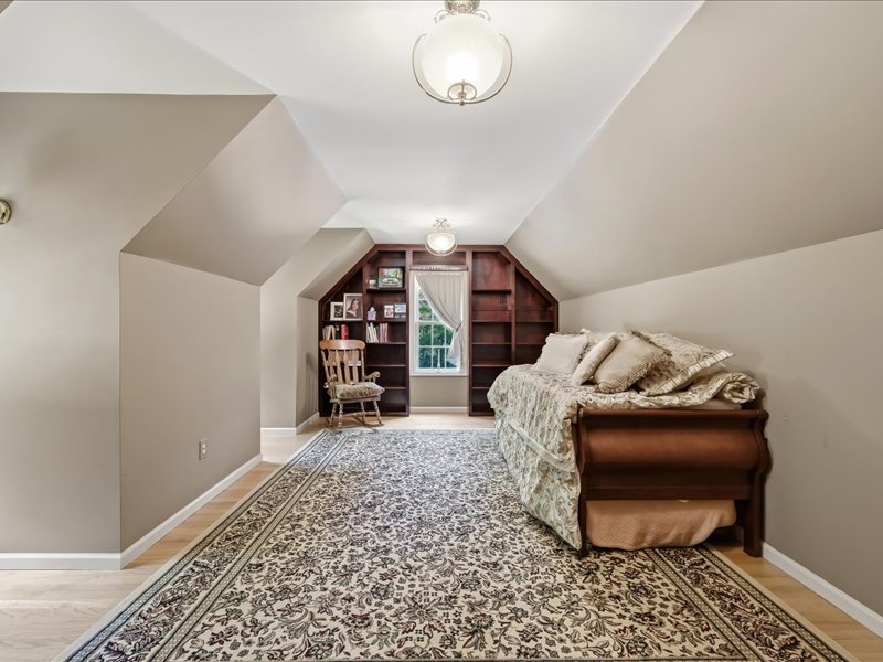 1168 Mt Pleasant Road Bangor, PA 18013 - Photo 66 of 100 Angled ceilings and custom built-in bookshelves frame this charming upper-level space finished with hardwood flooring.