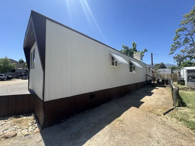 a view of a backyard with sitting area