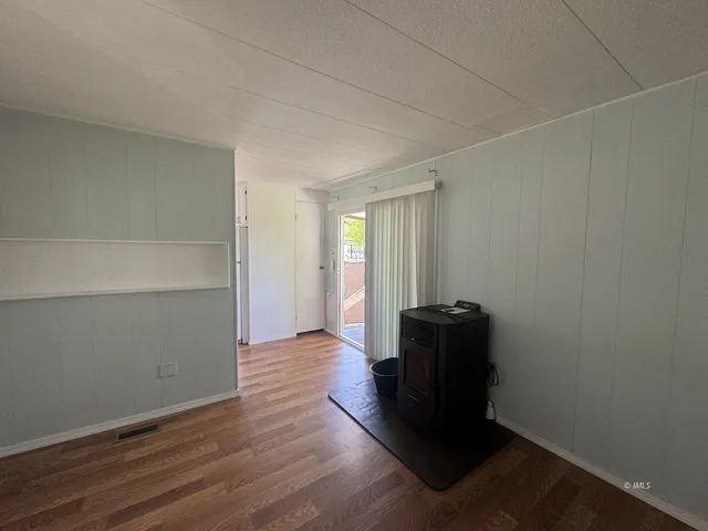 a view of an empty room and wooden floor