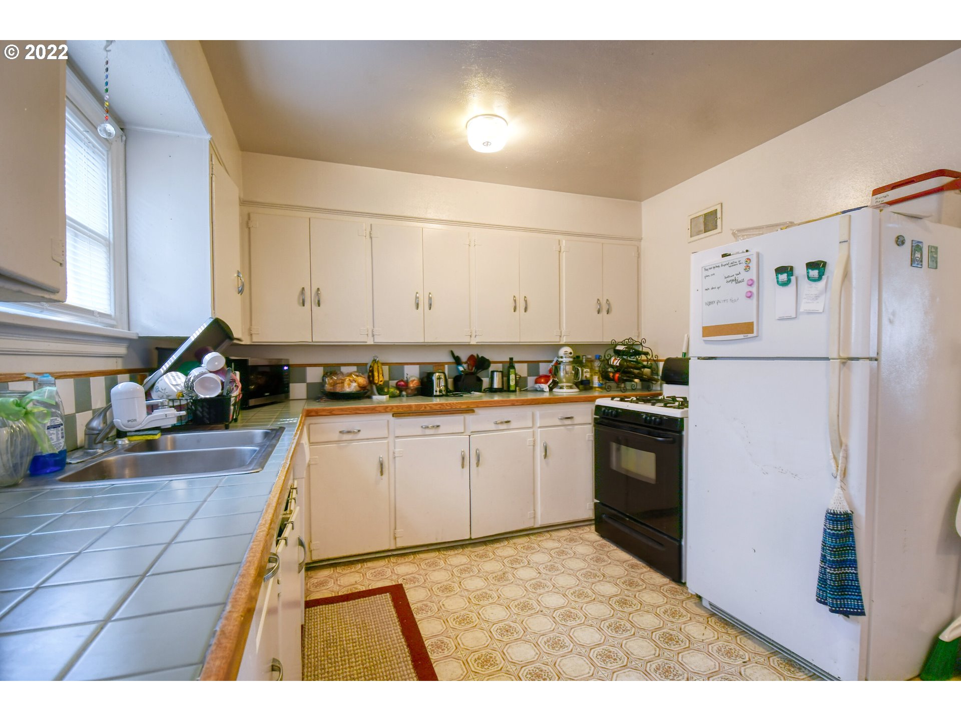 1302 Southwest Goodwin Lane Pendleton, OR 97801 - Photo 15 of 21 a kitchen with a refrigerator and a stove