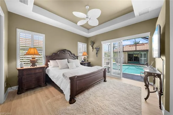 a bedroom with a bed and a chandelier