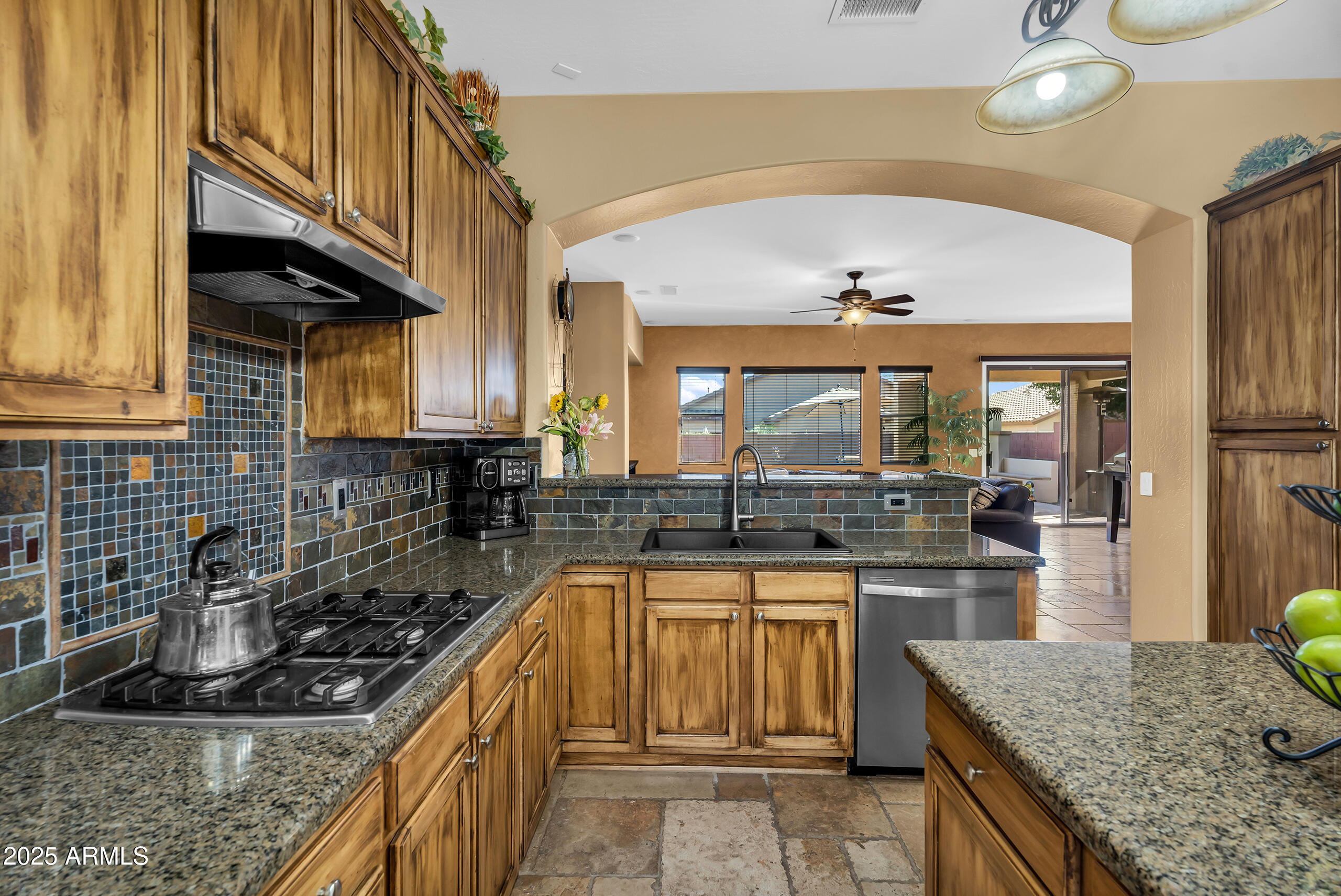 4821 East Kirkland Road Phoenix, AZ 85054 - Photo 10 of 22 a kitchen with stainless steel appliances granite countertop a sink and stove