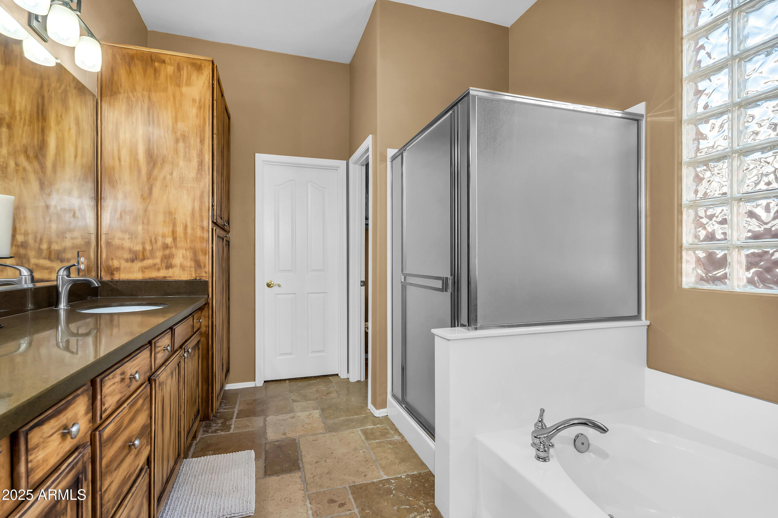 4821 East Kirkland Road Phoenix, AZ 85054 - Photo 16 of 22 a bathroom with a granite countertop sink and a bathtub