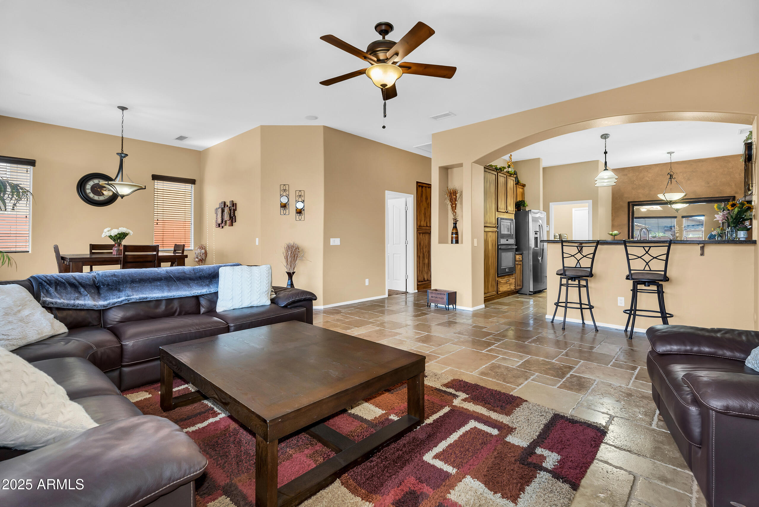 4821 East Kirkland Road Phoenix, AZ 85054 - Photo 6 of 22 a living room with furniture a table and kitchen view