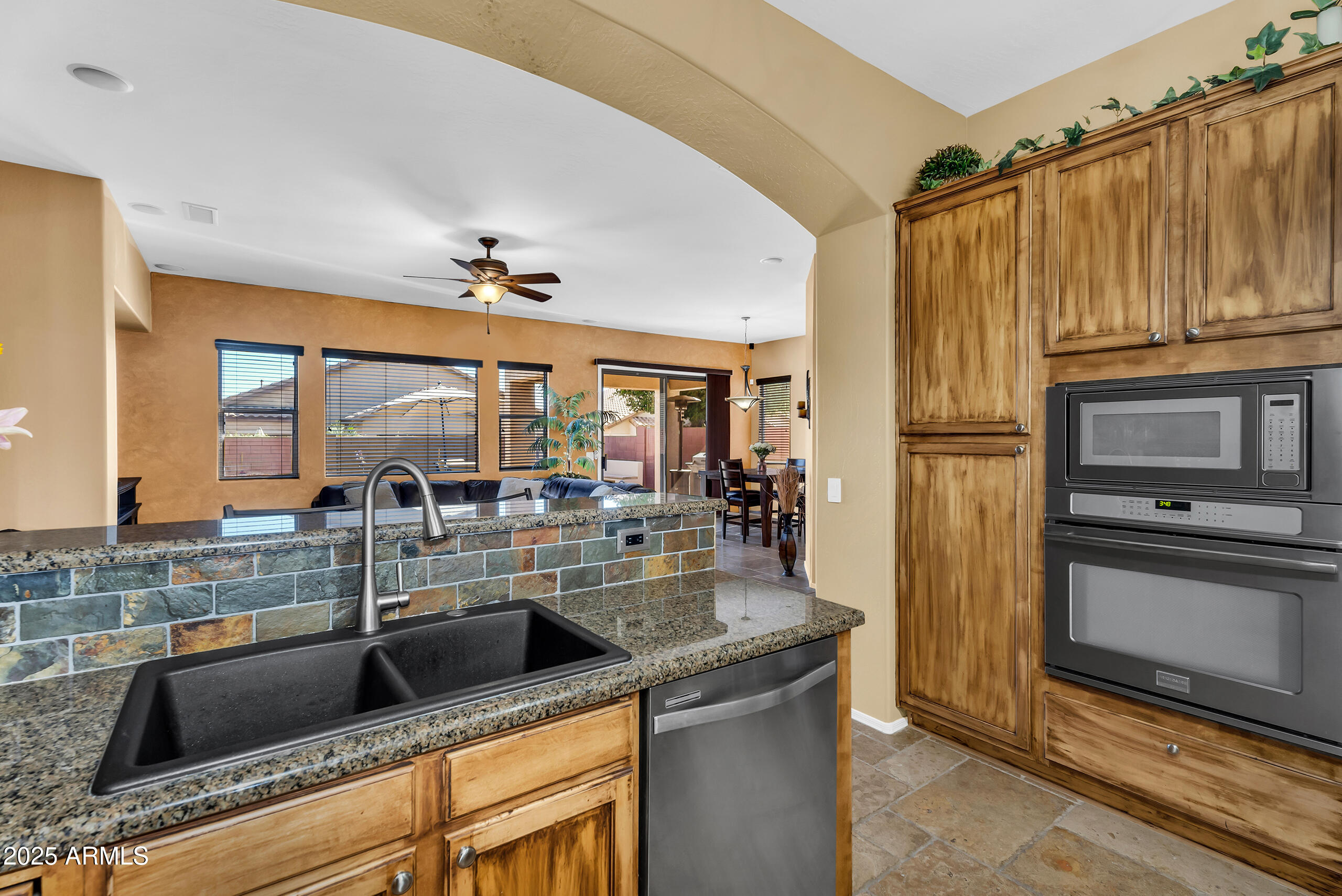 4821 East Kirkland Road Phoenix, AZ 85054 - Photo 9 of 22 a kitchen with stainless steel appliances granite countertop a sink and a refrigerator