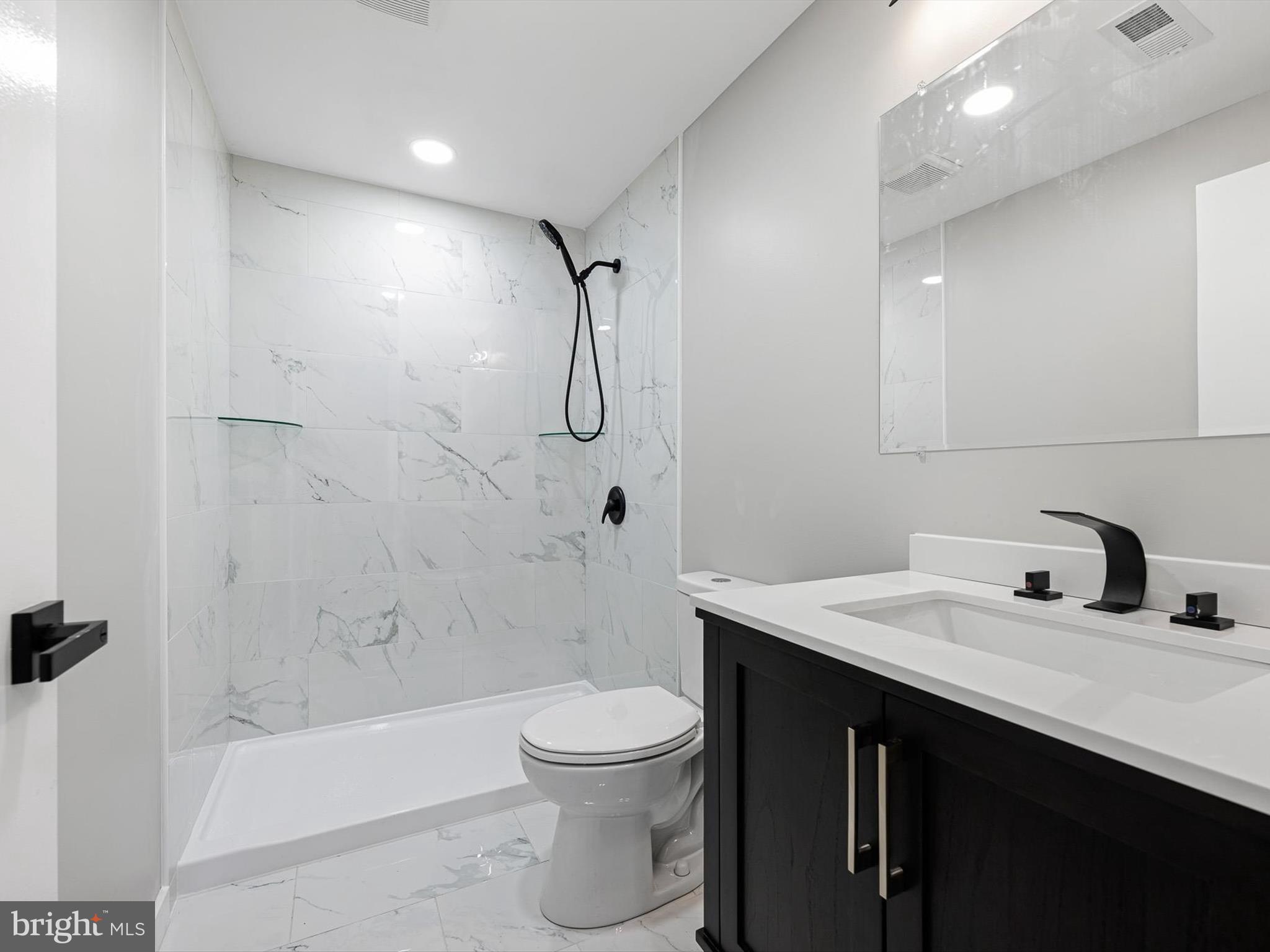 22832 Angola Road East Lewes, DE 19958 - Photo 13 of 43 a bathroom with a sink a toilet and shower