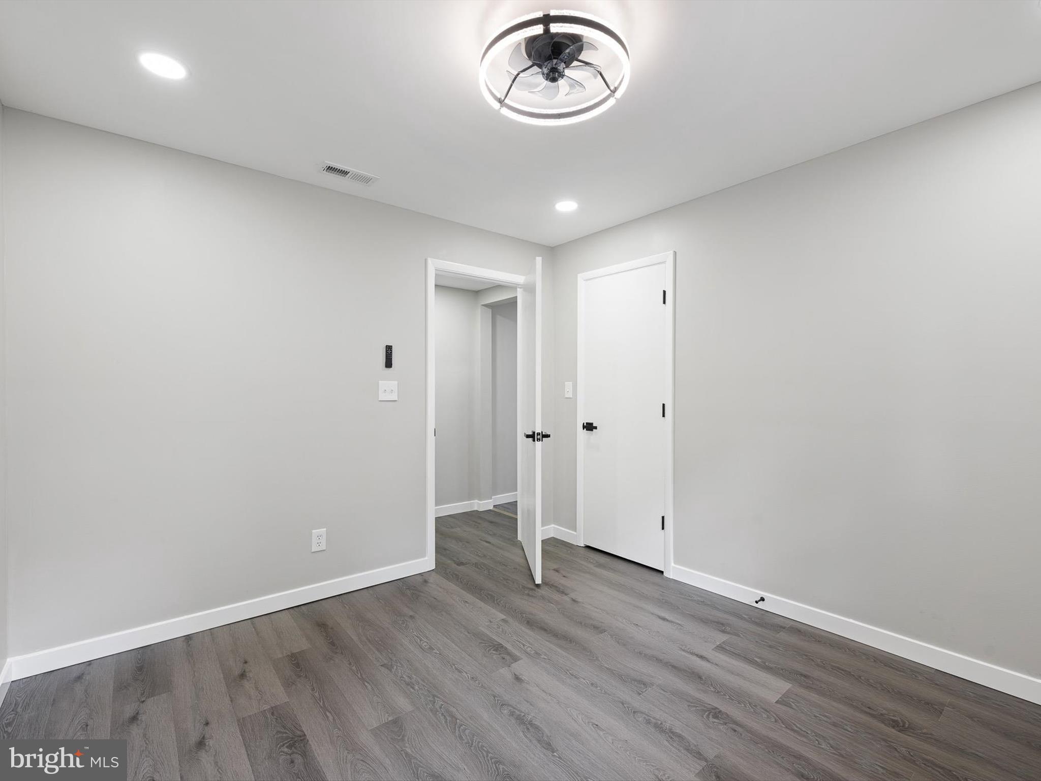 22832 Angola Road East Lewes, DE 19958 - Photo 17 of 43 an empty room with wooden floor and a window